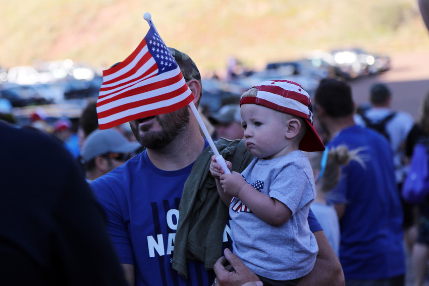 Benjiman Martinez waves the American Flag as his father, Ben Martinez, of Castle Rock, prepared to participate in the 10th annual 9/11 Star Climb at Red Rocks.